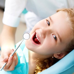 Girl smiling in dental chair 