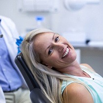 A woman smiling in the dental chair