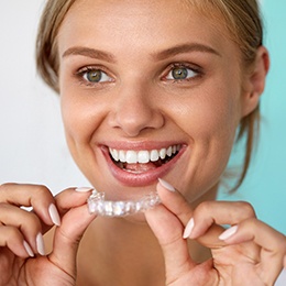 Lady placing her Invisalign clear brace