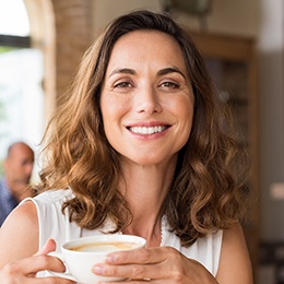 Smiling woman with cup of coffee