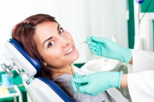 Woman smiling in the dentist's chair.