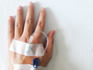 Close-up of patient’s hand prepared for IV sedation