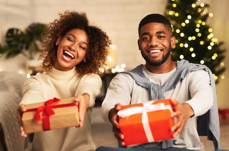 Smiling couple holding presents