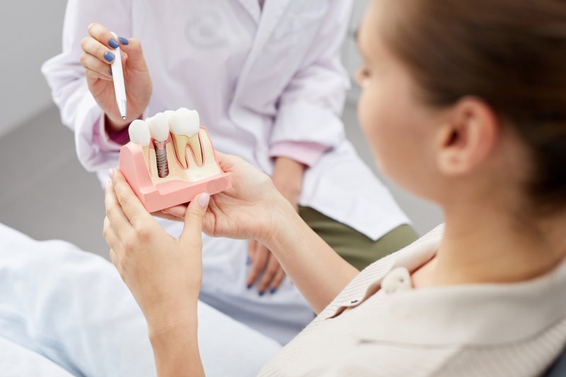 A dentist explaining whether dental implants can rust